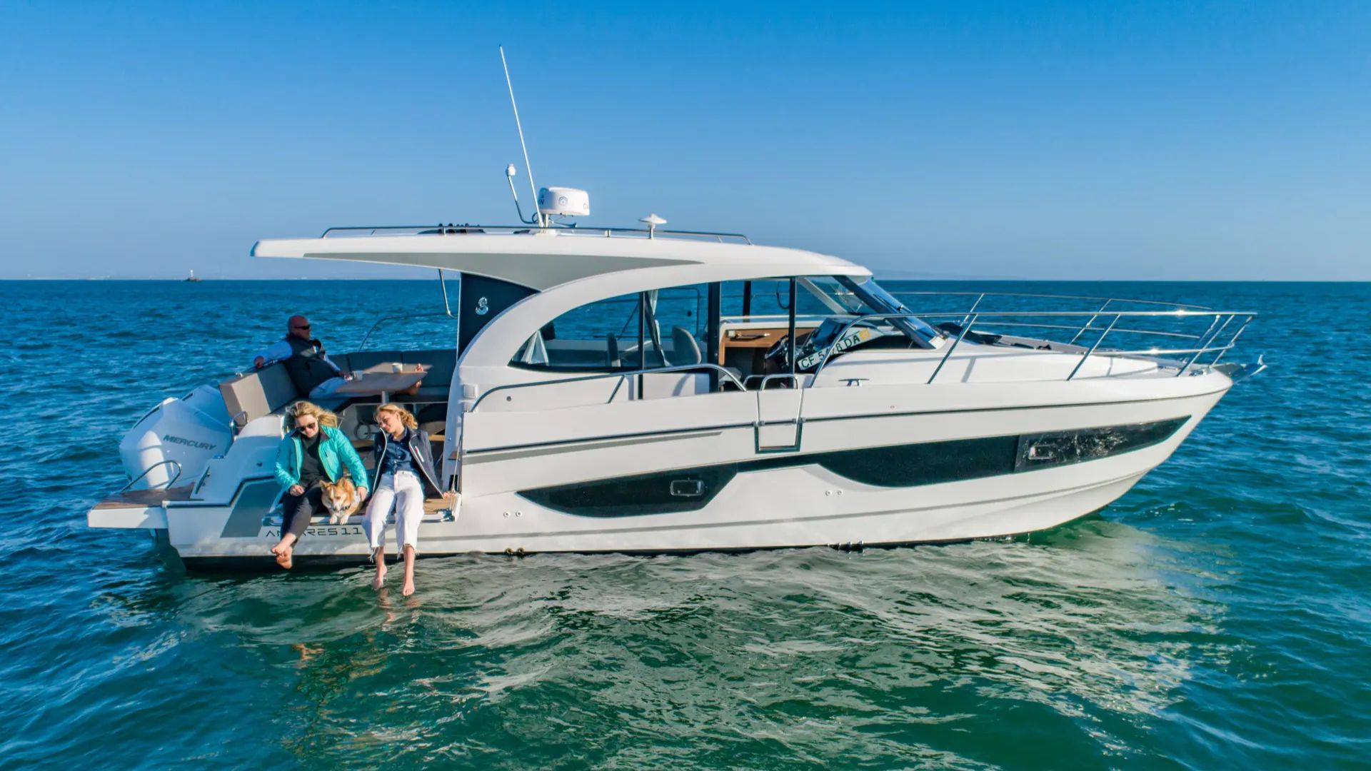 Beneteau Antares 11 Coupe on Water, Sitting on Side of Boat with Feet in Water